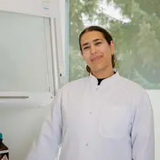 Employee portrait of an oil chemistry specialist in a laboratory or office setting.