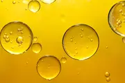 Close-up of oil with suspended water droplets, illustrating moisture contamination in lubricating and hydraulic fluids.