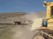 Mining haul trucks operating in an open-pit environment with crusher and conveyor systems, where clean oil and deep oil filtration protect gearboxes from abrasive wear and extend service life.