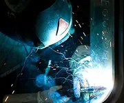 Close-up of welding work on a marine window or frame construction component.
