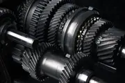 Close-up of gearbox gears and bearings in operation, illustrating how clean gear oil and effective oil filtration protect components from wear and extend gearbox service life.