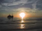 Offshore vessel operating at sea during sunset, representing how clean oil and reliable oil filtration support continuous marine and offshore operations in remote environments.