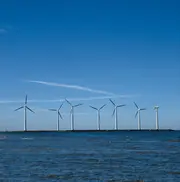 Offshore wind turbines along the coastline, representing wind energy operations where clean oil and advanced oil filtration protect gearboxes and hydraulic systems in harsh marine environments.