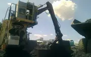 Heavy mining excavator loading material into a haul truck, illustrating how clean oil and advanced oil filtration protect hydraulic systems and engines in demanding mining operations.