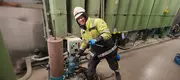 Service technician performing maintenance on an industrial oil filtration system during on-site service.