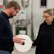 Technicians inspecting filtration equipment, demonstrating how advanced oil filtration technology restores clean oil and reduces contamination in operating systems.
