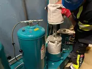 Technician replacing a filter insert in a phosphate ester oil filtration unit.