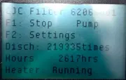 Digital display on CJC® filtration unit showing operating hours and discharge count during operation.