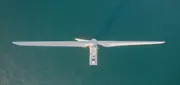 Aerial view of an offshore wind turbine representing wind energy production.