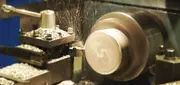 Molten metal being poured into a mould in a foundry, illustrating special casting applications for machine and food industry components.