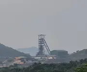 Mining site with ball mill processing equipment used in mineral extraction operations.
