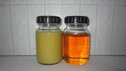 Comparison of contaminated and clean lubricating oil samples showing filtration effectiveness