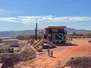 Large Caterpillar mining haul truck operating at an open-pit iron ore mine.