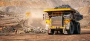 Large mining haul truck transporting ore in an open-pit mine, illustrating how clean oil and effective oil filtration protect engines and hydraulic systems in heavy-duty mining operations.