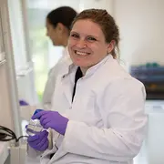 Employee portrait of an oil chemistry specialist working in a laboratory environment.