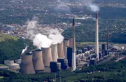 Aerial view of a large thermal power station with cooling towers and chimney stacks, where clean oil and advanced oil filtration safeguard turbines and auxiliary systems to maintain reliable power generation.