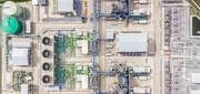 Aerial view of a power generation facility with cooling units and turbine buildings, representing turbine and transformer oil systems where acidity control protects critical assets.
