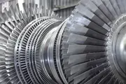 Close-up of large steam turbine rotor blades inside a power plant, representing critical rotating equipment that requires dry, water-free lubrication for reliable operation.