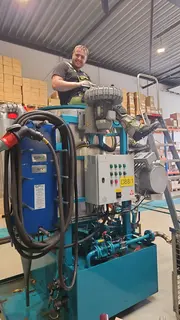Technician preparing a portable CJC rental oil filtration unit in a workshop, ready for deployment to support critical oil systems.